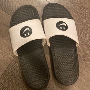 Black & white Nike Smile slides